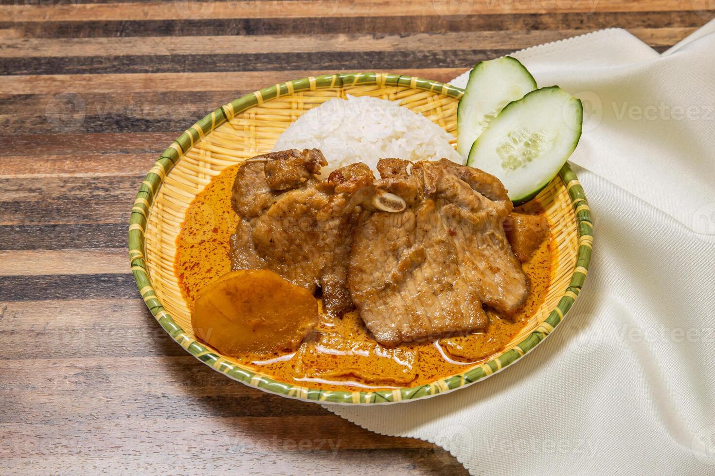 Pork chop curry with rice served in dish isolated on wooden table top view of hong kong fast food photo