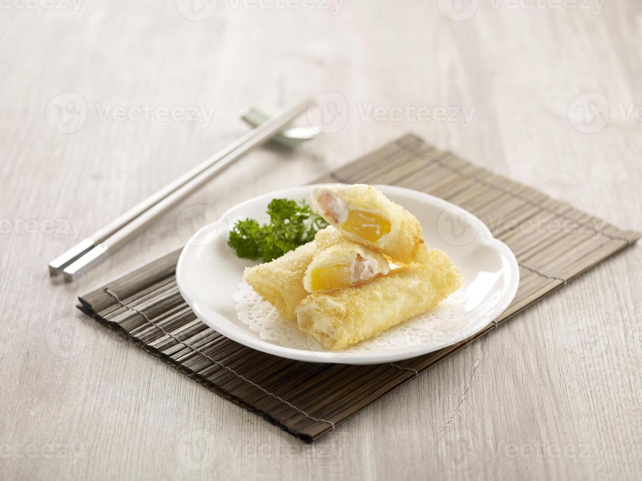 Crispy Prawn and Mango Fritter Served in a dish isolated on wooden board side view on grey background photo