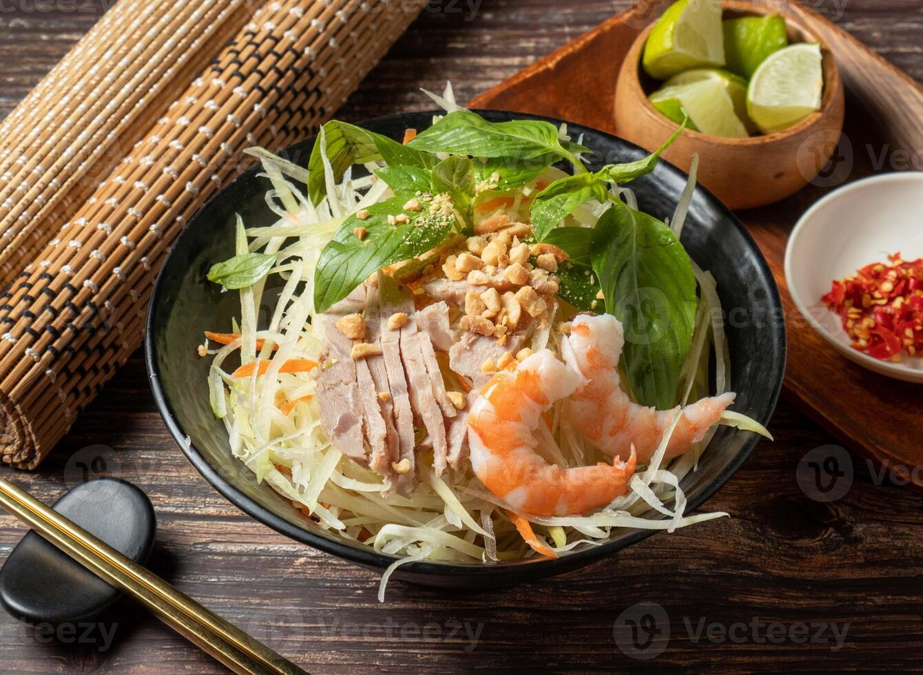 Shredded Papaya shrimp salad served in bowl isolated on table top view of taiwan food photo