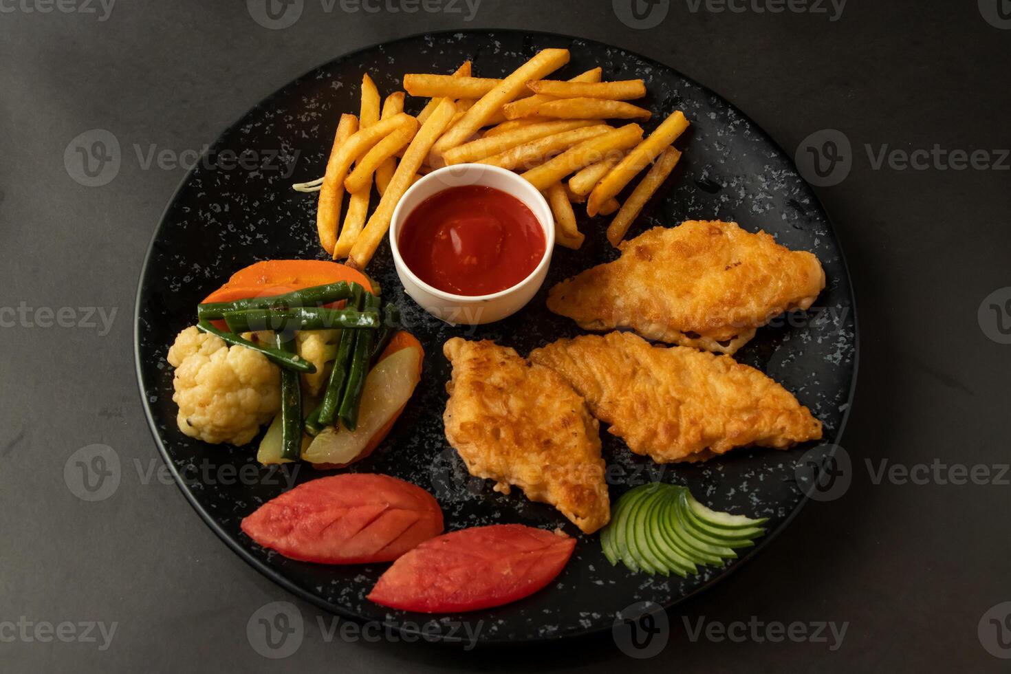 Grilled Fish and chips, fries, ketchup and swatted vegetables served in dish isolated on background top view of bangladesh and indian food photo