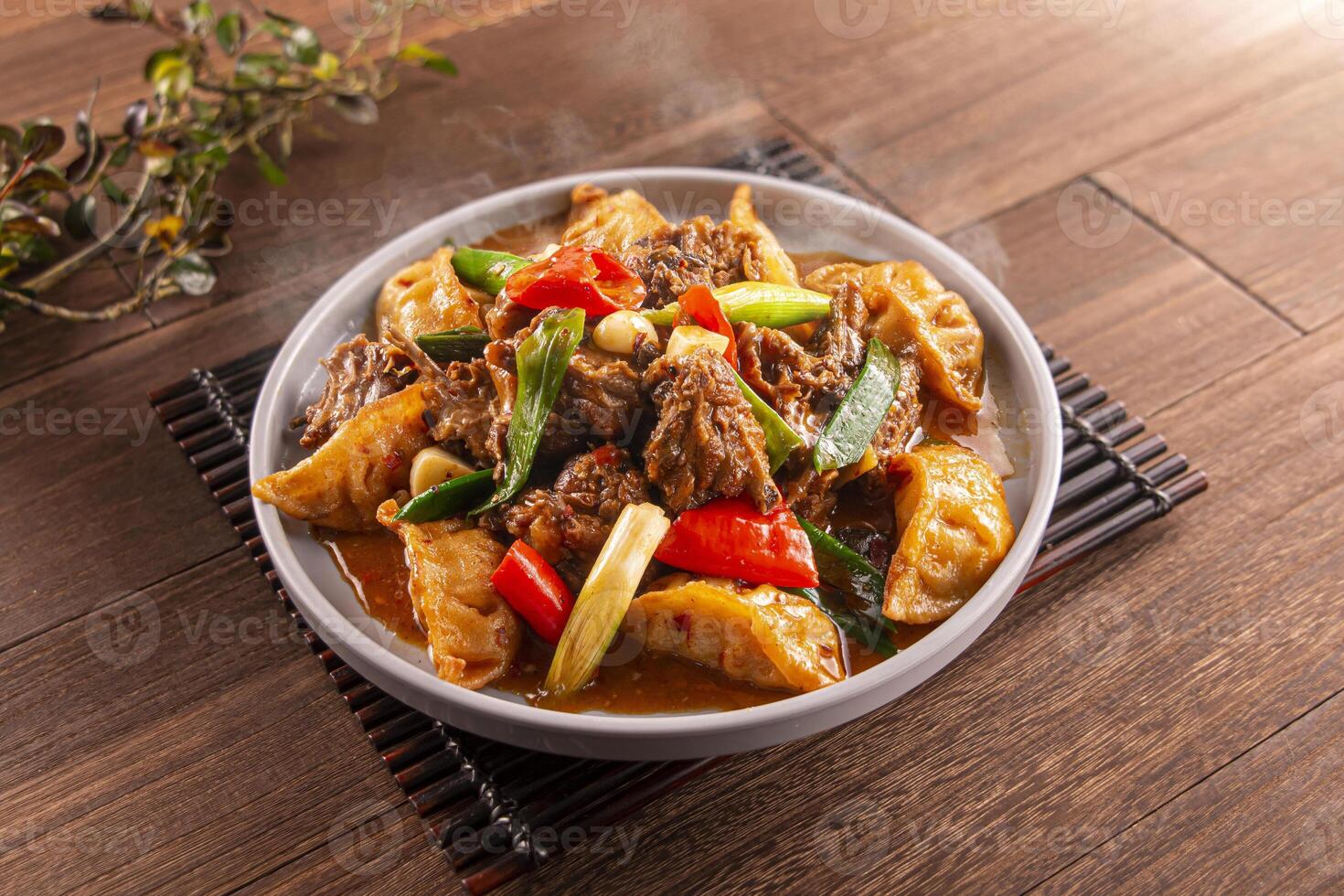 Farmhouse Spicy Duck Dumplings with tomato served dish isolated on wooden table top view of Hong Kong food photo