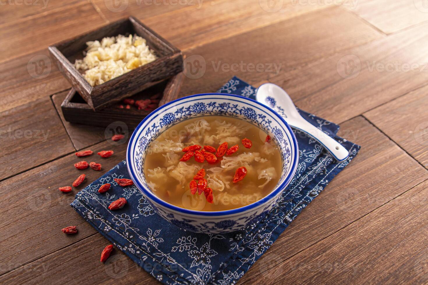 Thawed Spicy Frozen Sweet Soup Red Dates, Snow Fungus and Lotus Seeds served dish isolated on wooden table top view of Hong Kong food photo