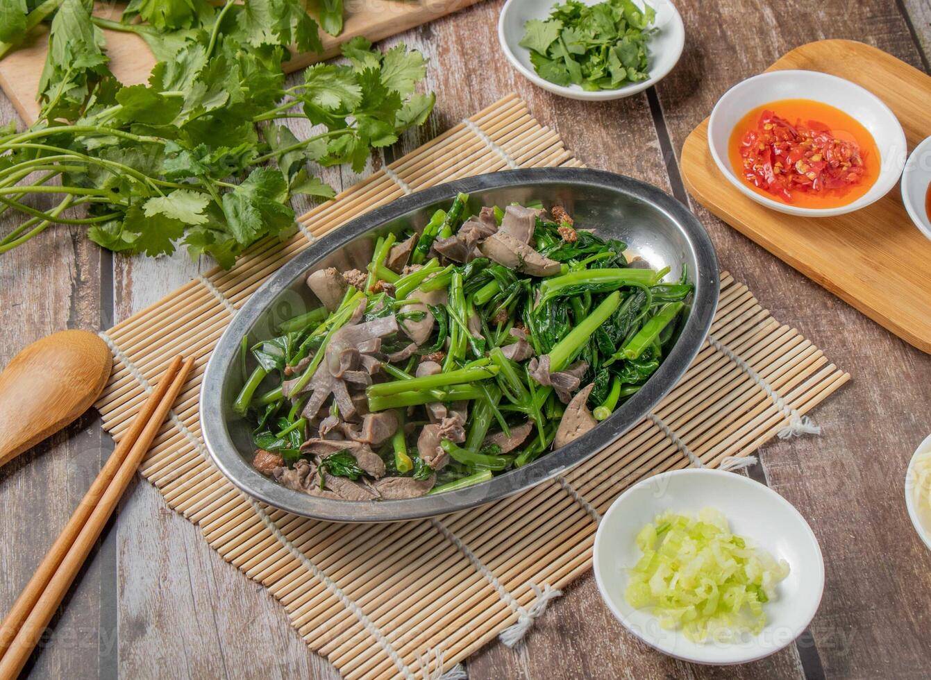 Pork Meat with Mix vegetables with chilli sauce, noodles, spoon and chopsticks served in dish isolated on napkin top view of hong kong food photo