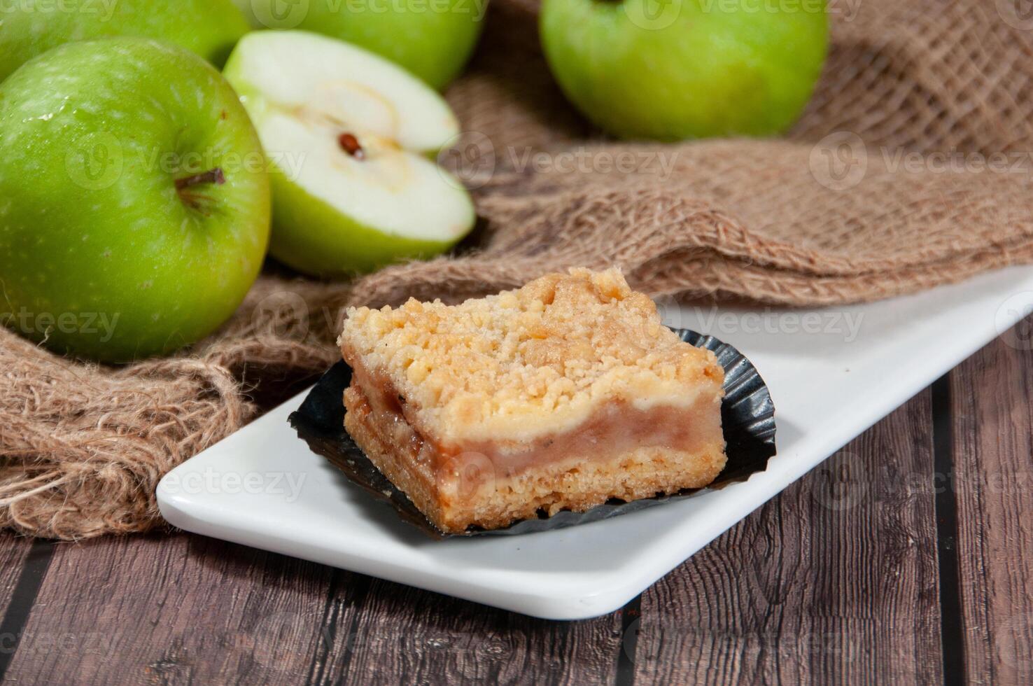 Apple Crumbles Tart Served in a dish side view on grey background photo