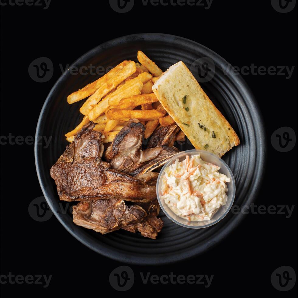 Lamb Chop with french fries served in a dish side view on black background fast food photo