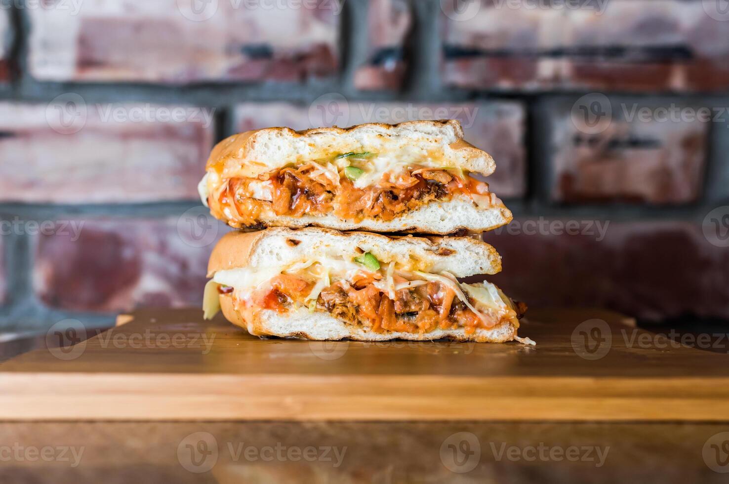 Cheesy Sub Sandwich isolated on wooden board top view on table fastfood photo