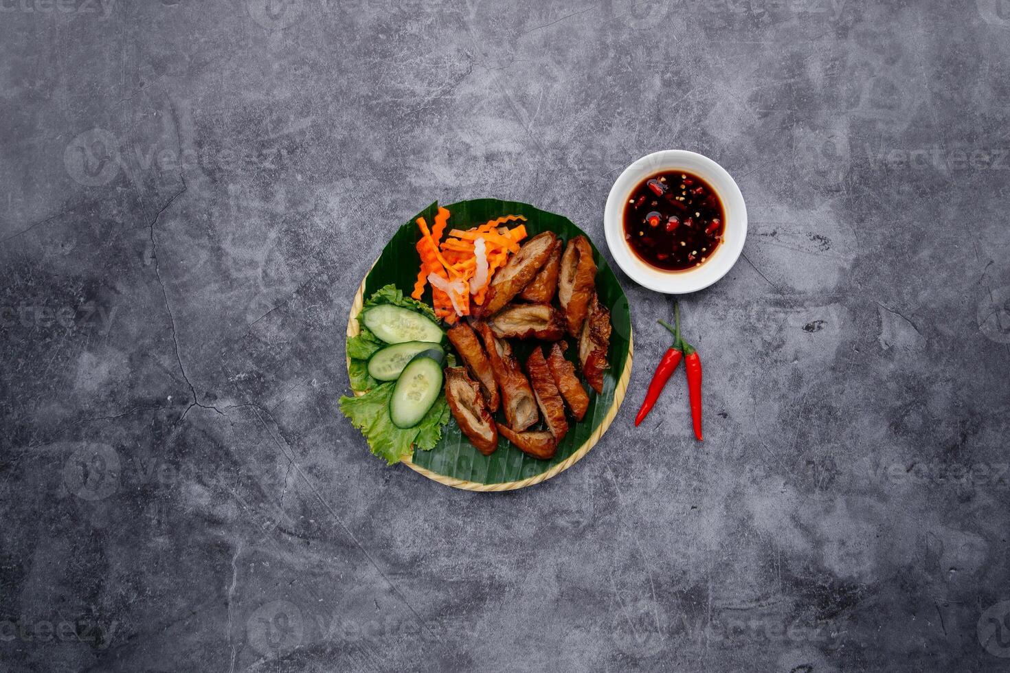 Deep Fried Pig Intestine With Fish Sauce and salad served in bowl isolated on dark grey background top view of japanese food photo