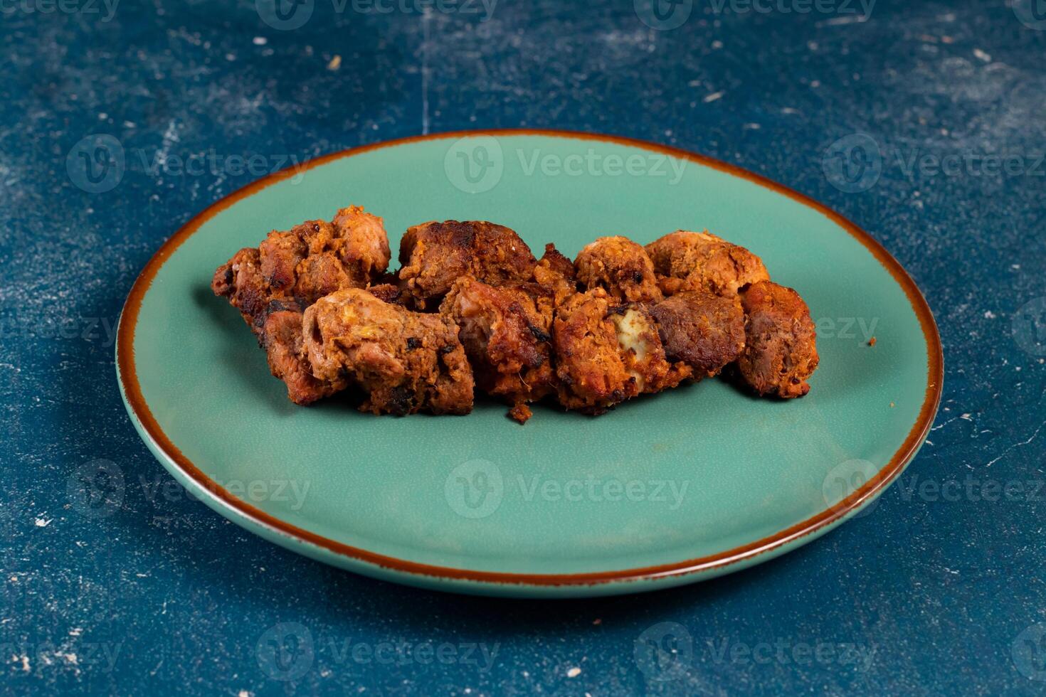 spicy bbq chicken tikka boti kabab served in a dish isolated on background top view photo