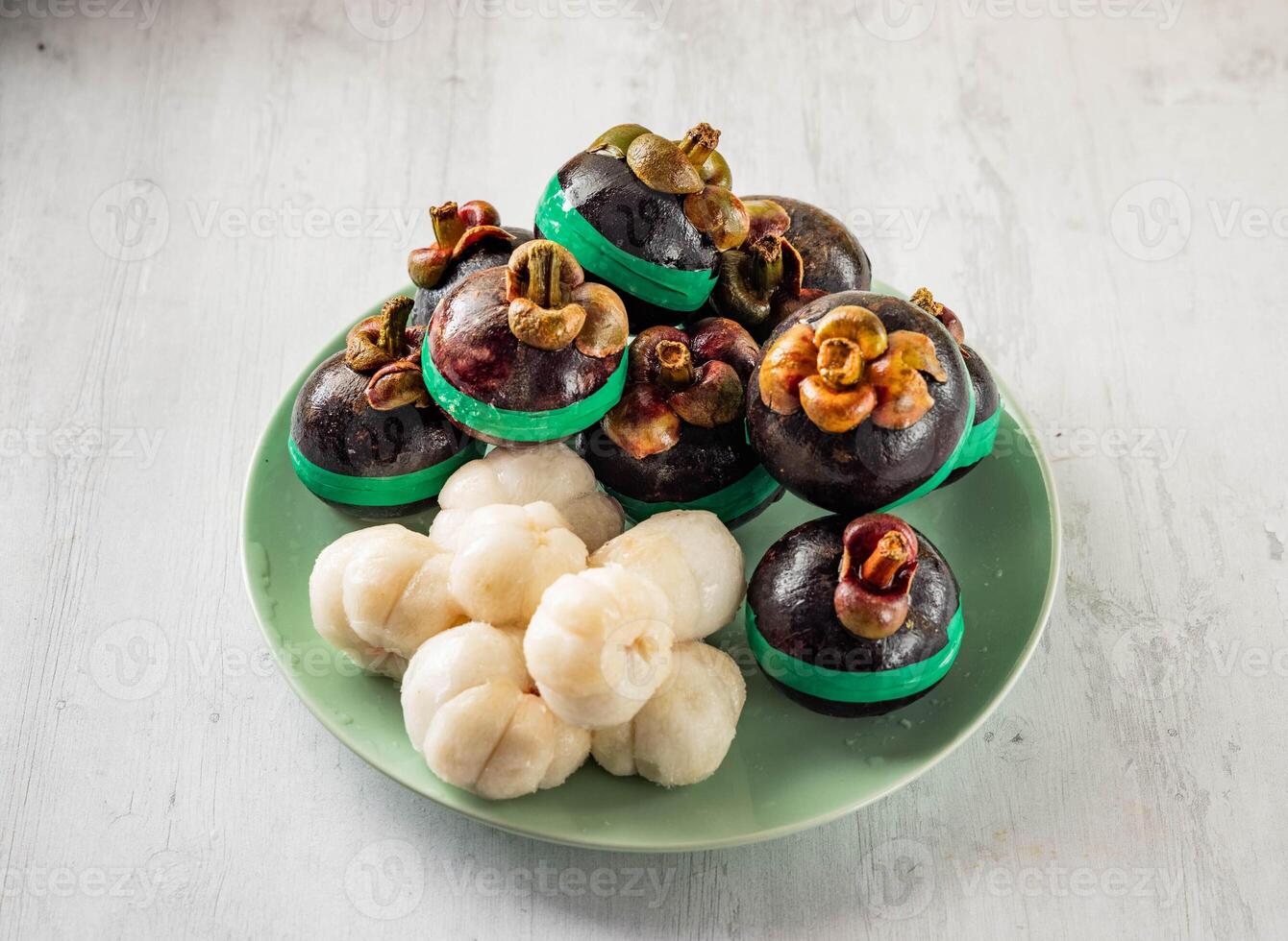 Mangosteen with shell with raw fruits served in disposable glass isolated on background top view taiwan food photo