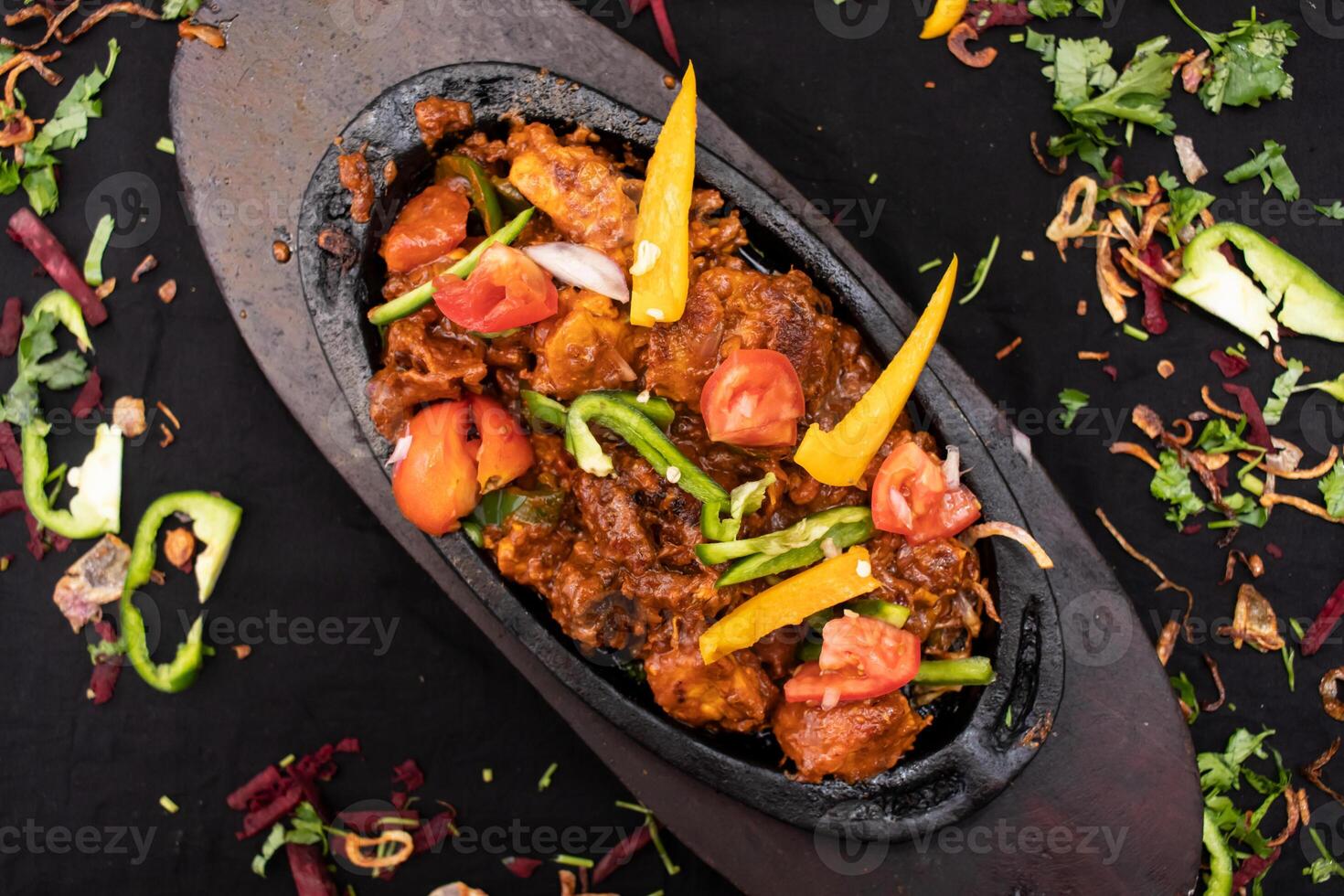 Chicken chaap or chop served in dish isolated on dark background top view of indian spices food photo