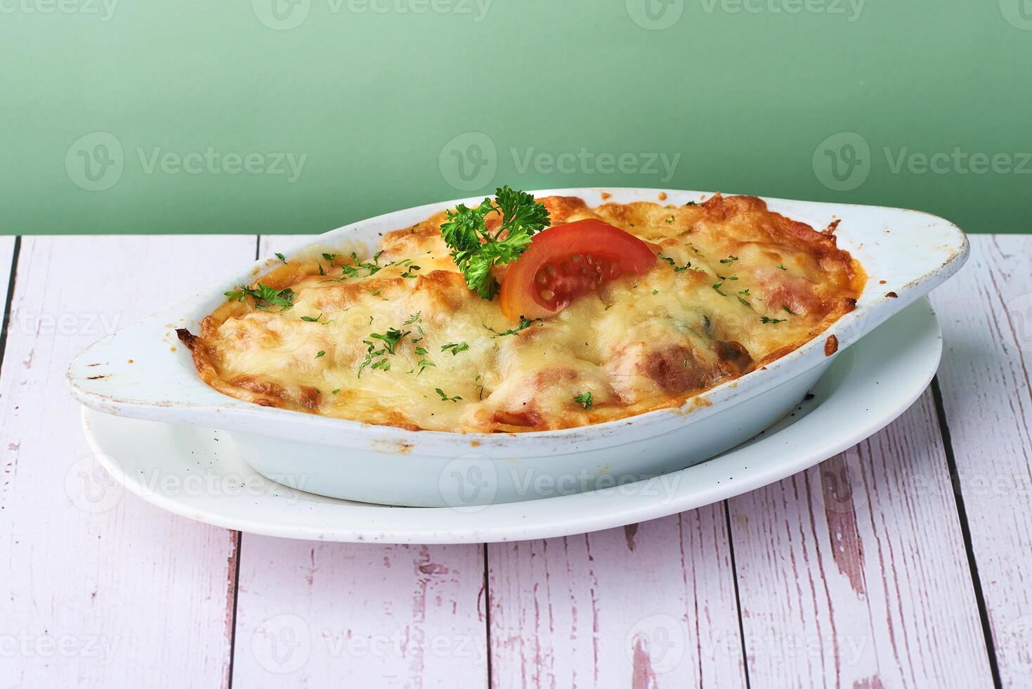 Italian Baked Pasta Pumpkin Tomato in white plate on wood table background photo