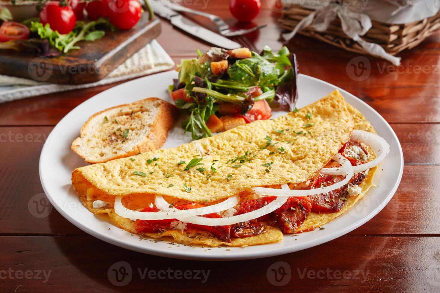 Greek Style cream sauce omelette roll with salad served in a dish isolated on wooden background side view photo