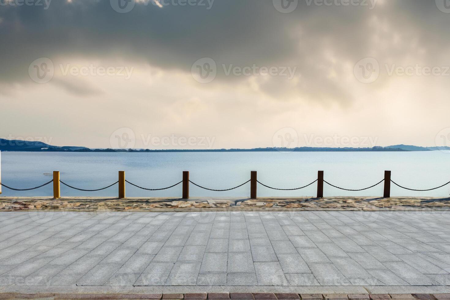 Tranquil Path Along Lovely Lake, Serene Scene under Clear Blue Skies. photo