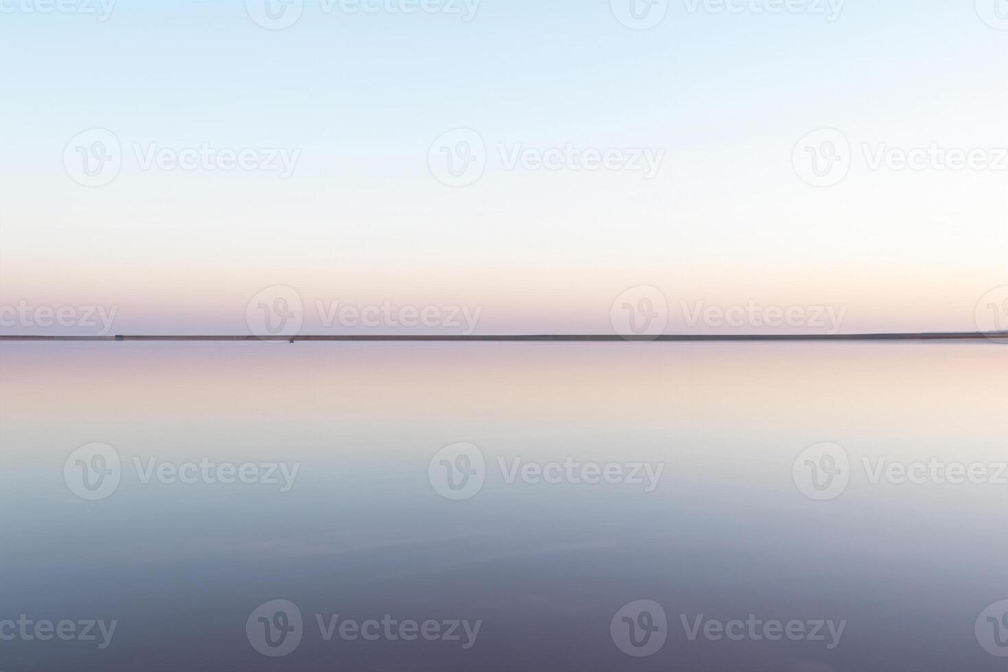 Tranquil Minimalist Landscape, Smooth Surface of Pink Salt Lake photo