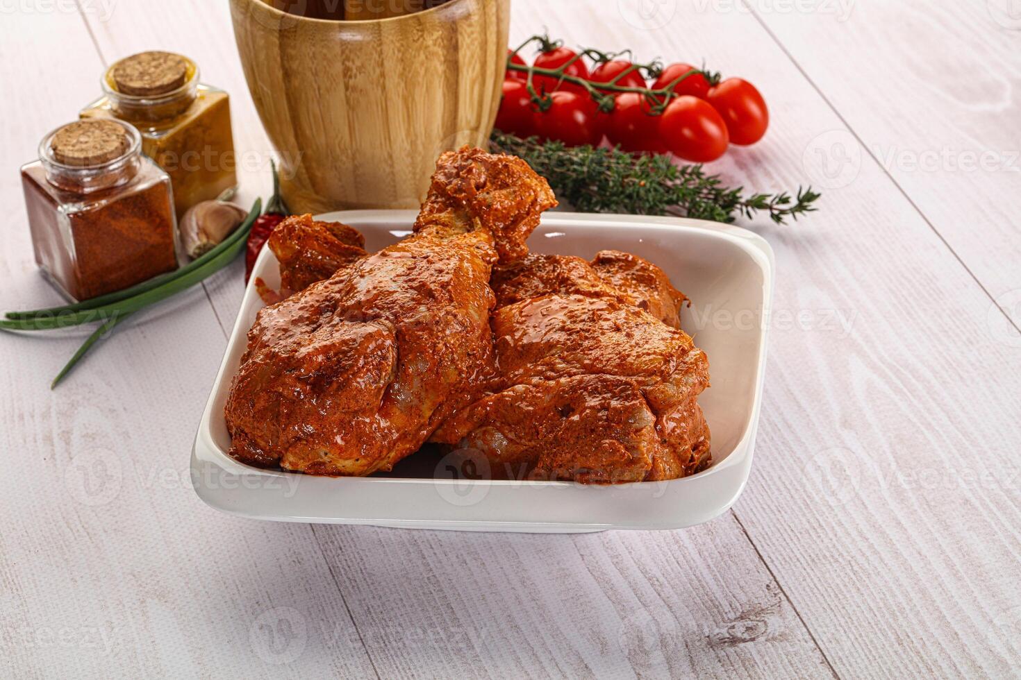 Raw turkey shoulder wing in Indian tandoori marinade photo