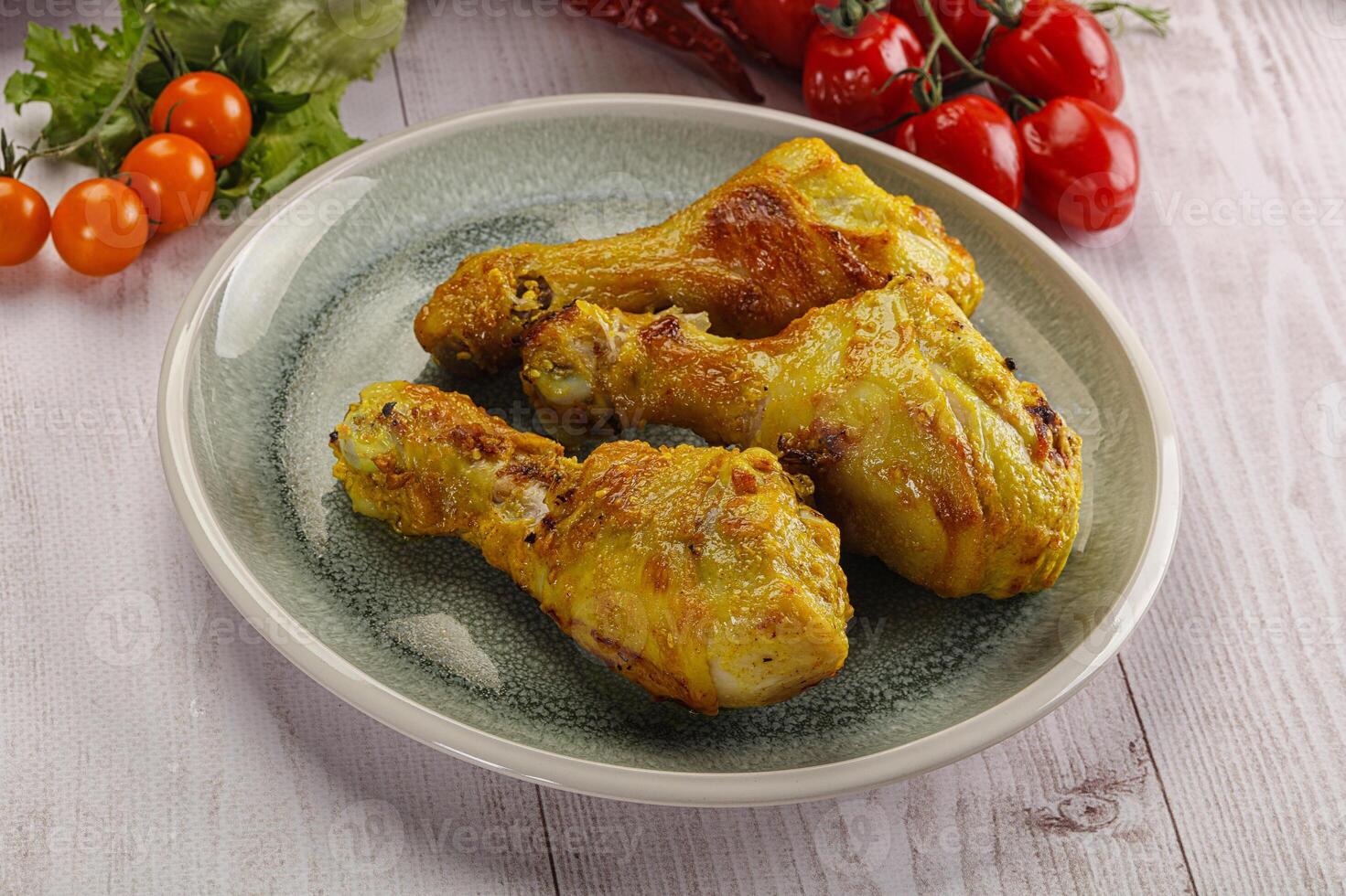 Roasted Chicken leg drumsticks with curry sauce photo