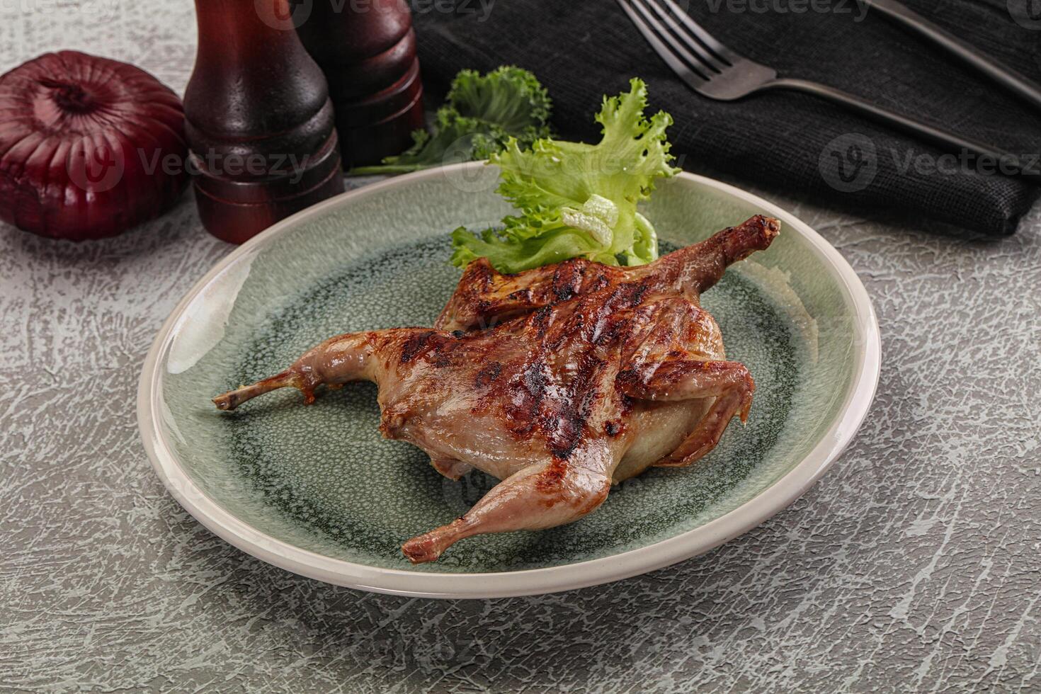 Grilled quail in the plate photo