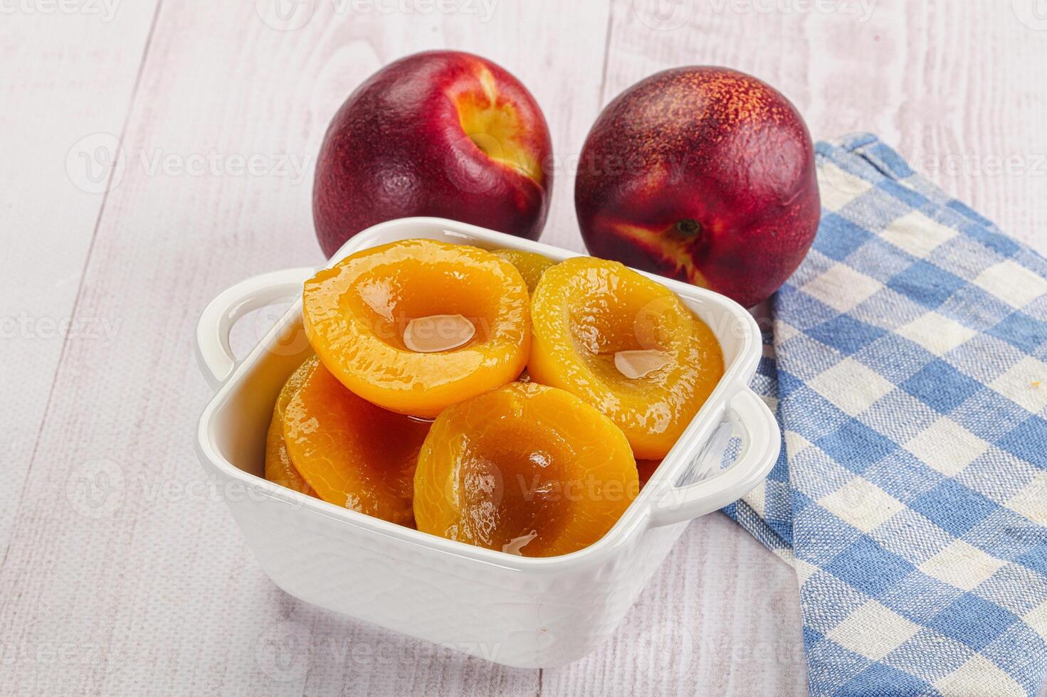 Canned peaches with sweet syrope photo
