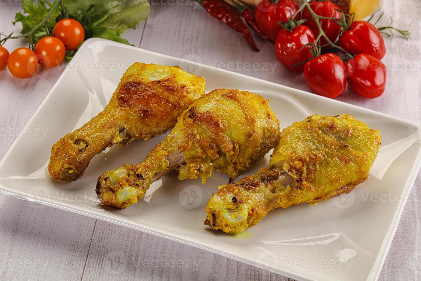 Roasted Chicken leg drumsticks with curry sauce photo