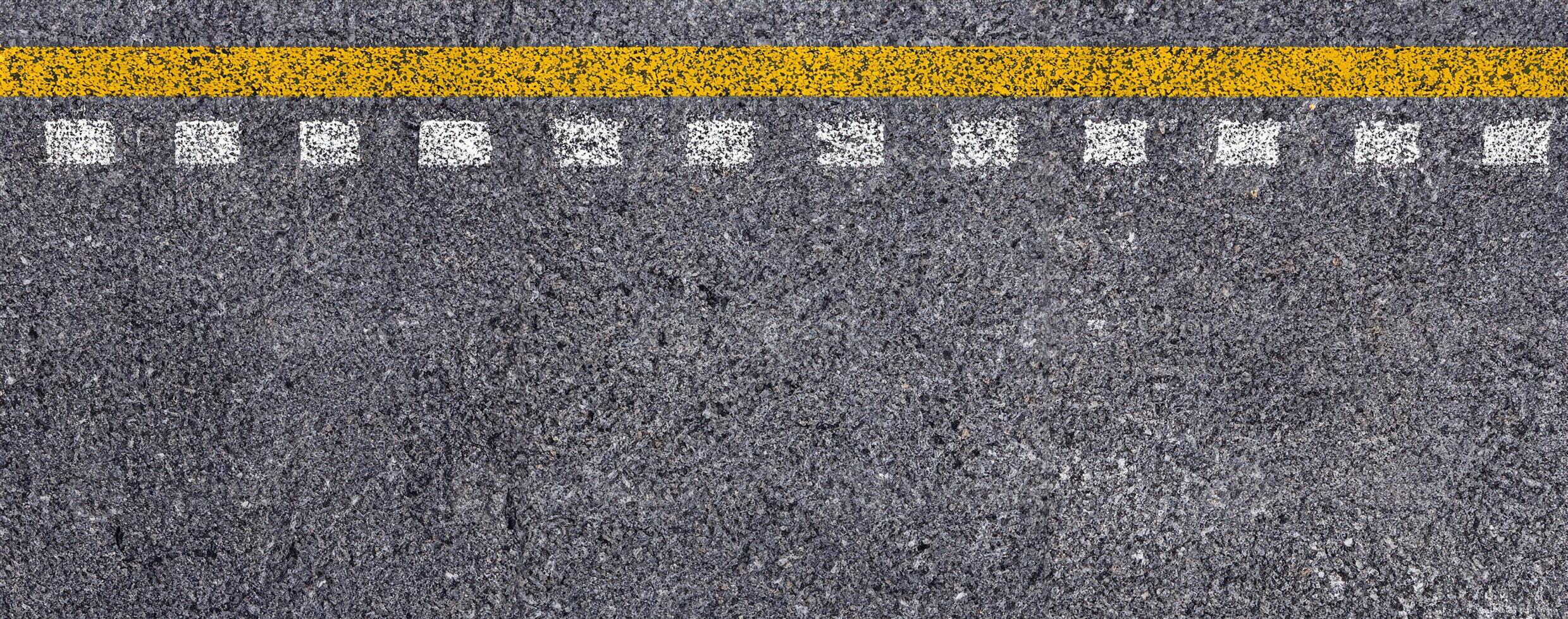 Top View of Double Yellow and White Lines on Asphalt Road Texture Background. photo