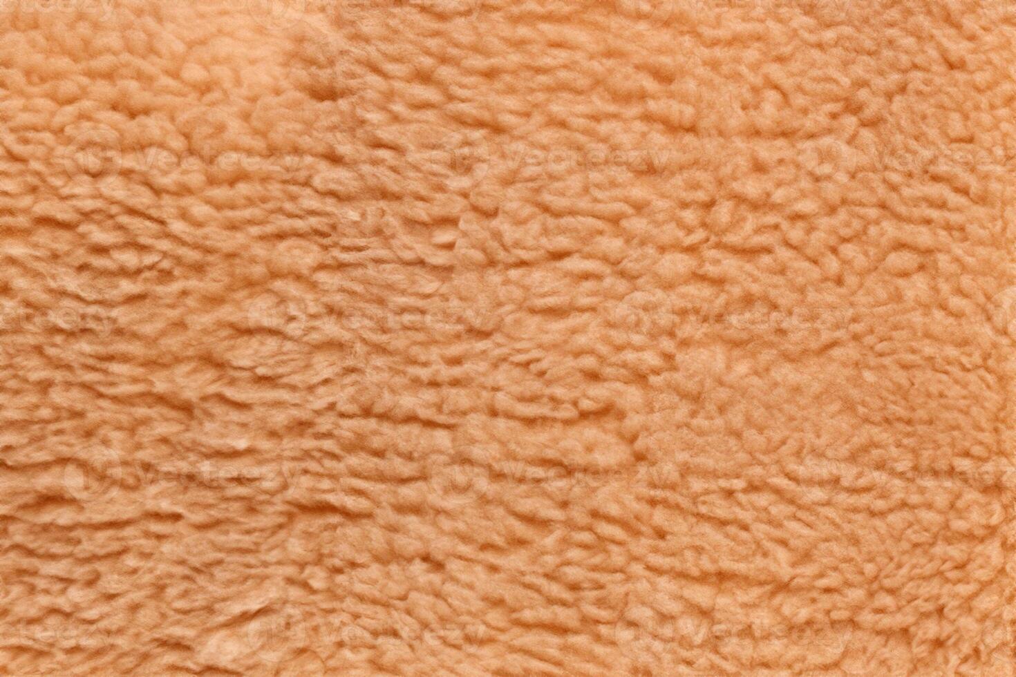 Cozy Texture, Soft Light Brown Teddy Bear Fabric Background. photo