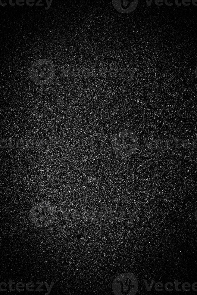Abstract Black Grainy Texture Overlay on Asphalt Background. photo