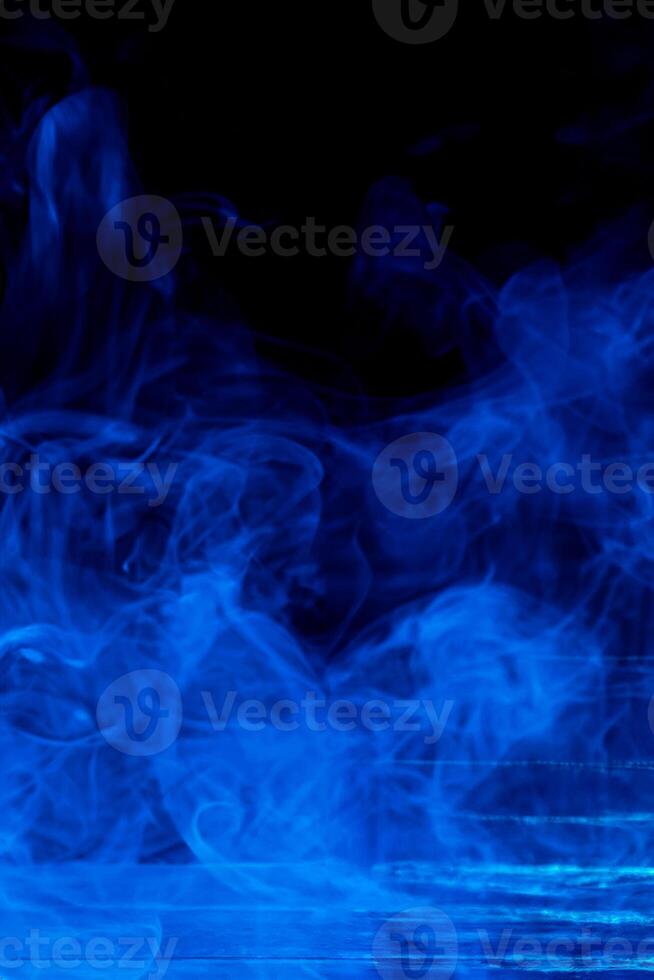 Abstract Blue Smoke Concept, Isolated on Dark Black Background with Wooden Table photo