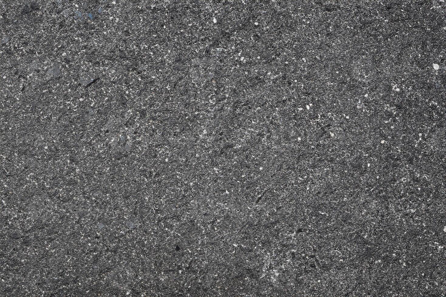 Texture of Dark Asphalt Road with Embedded Rocks, Urban Ground Background. photo