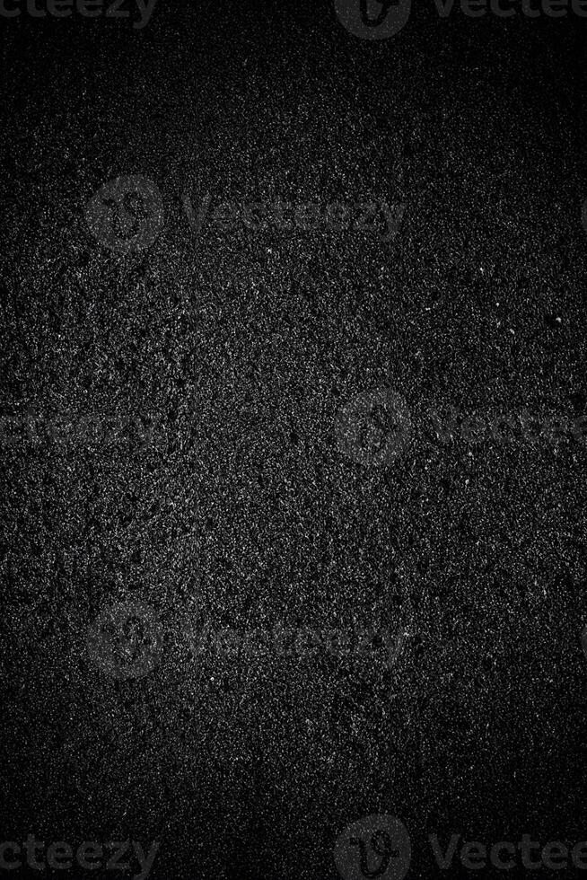 Abstract Black Grainy Texture Overlay on Asphalt Background. photo