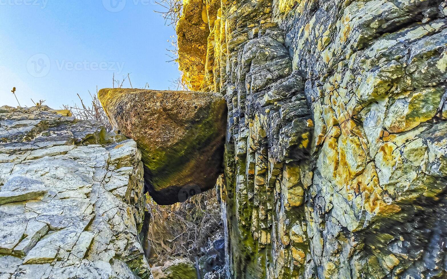 Rocks cliffs boulders mountain big rock stuck between mountains Mexico. photo