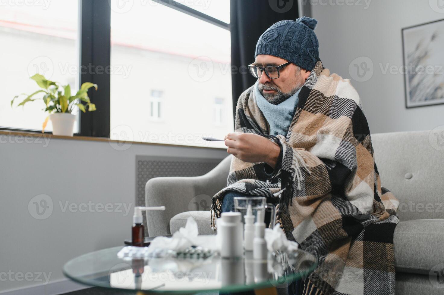 old man get a cold and sneeze with tissue paper at home photo