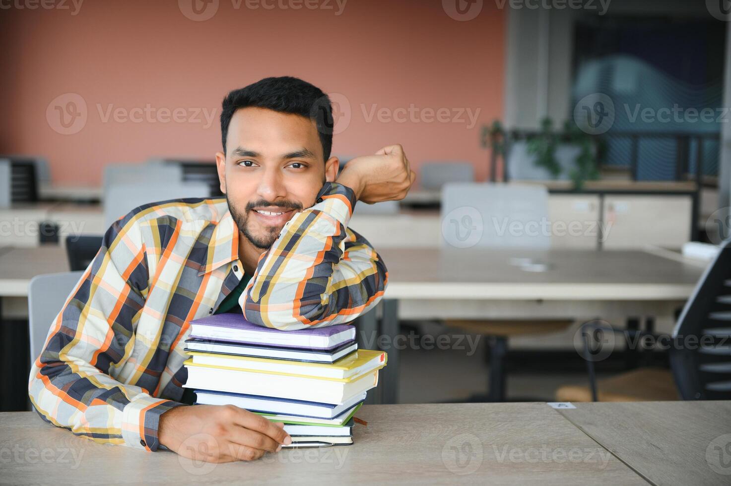 Happy indian male student at the university photo