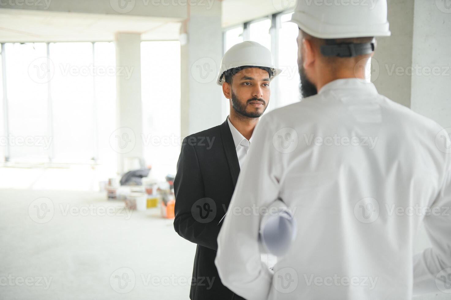 Construction concept of multiracial Engineer and Architect working at Construction Site with blue print photo