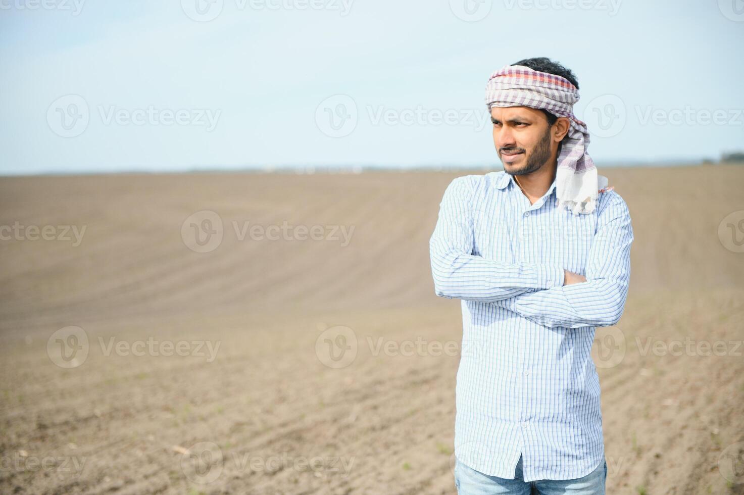 A young Indian farmer inspects his field before sowing. photo