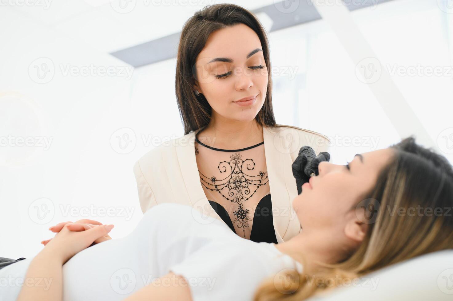 Permanent make up procedure. Lip makeup in tattoo salon. photo
