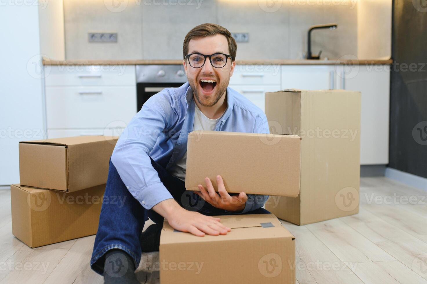 Smiling guy moving into his new home photo