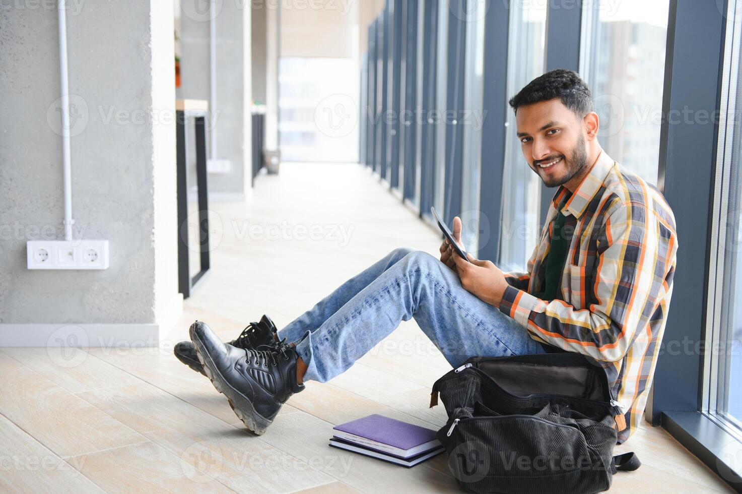 Happy indian male student at the university photo