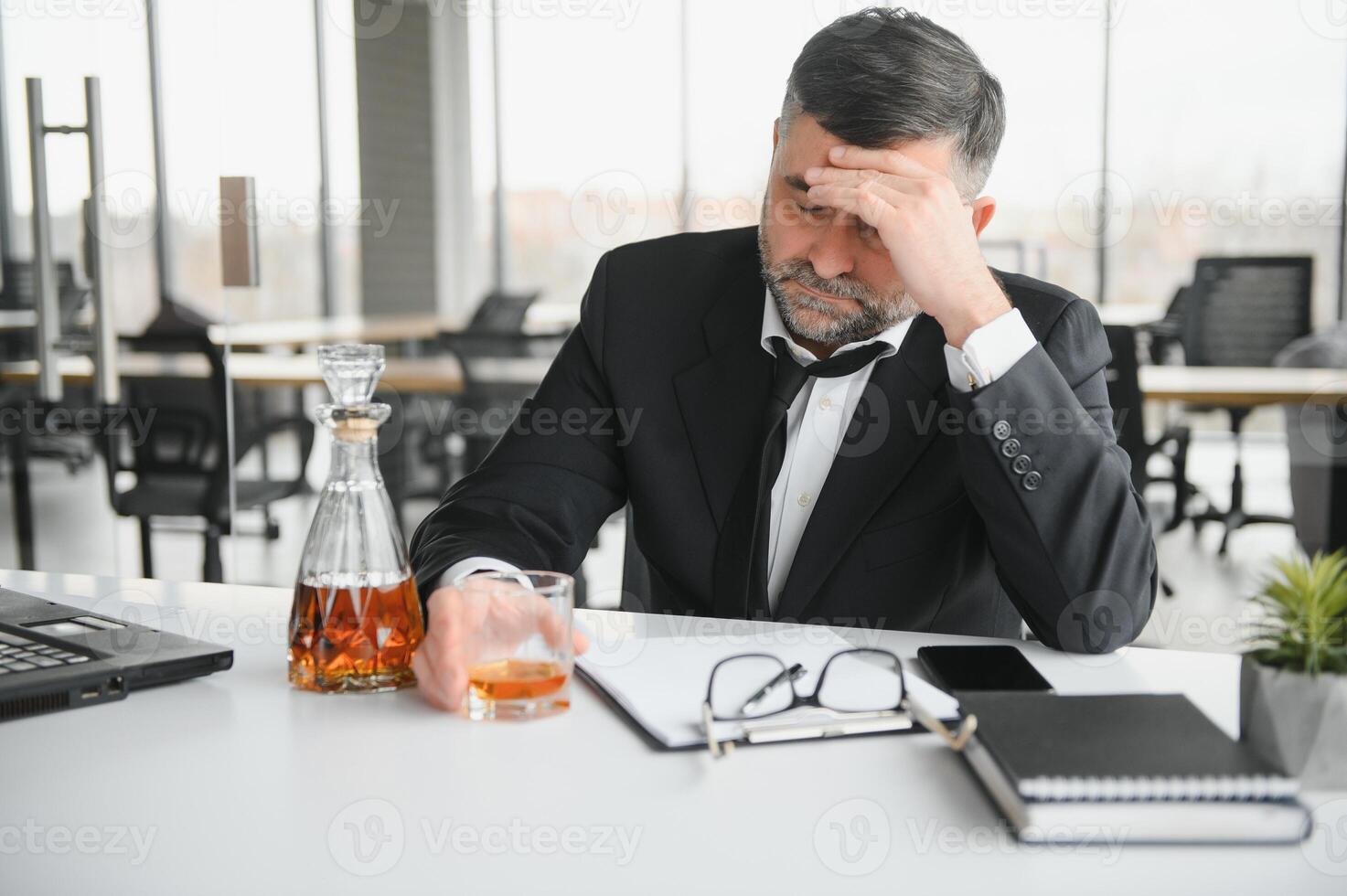 Old businessman drinking from stress. photo