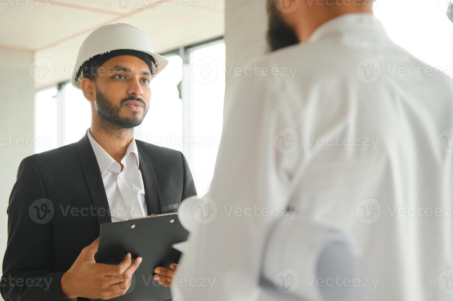 Construction concept of multiracial Engineer and Architect working at Construction Site with blue print photo