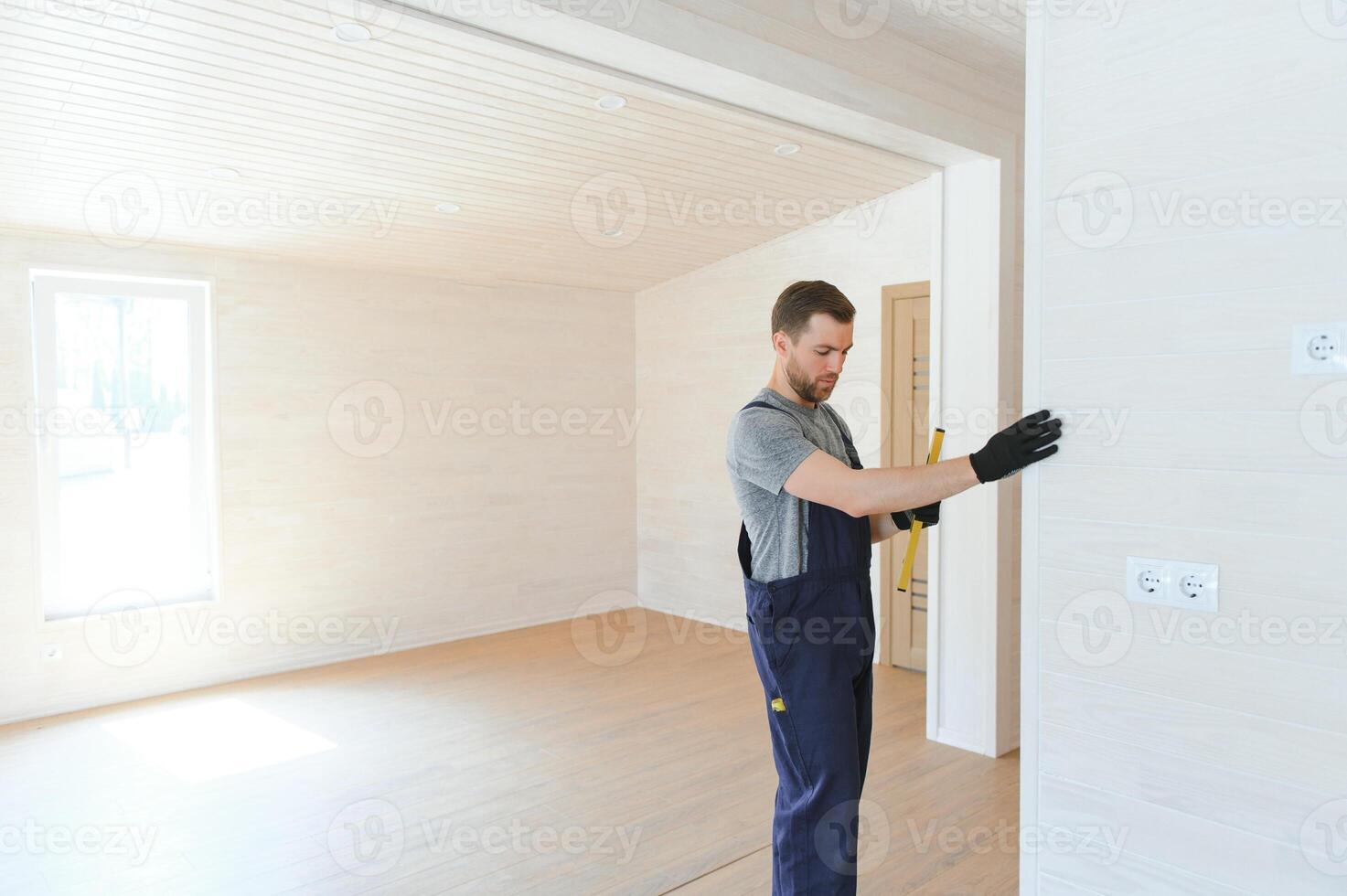 Process of construction new and modern modular house from composite sip panels. Worker man in special protective uniform wear working on building development industry of energy efficient property. photo