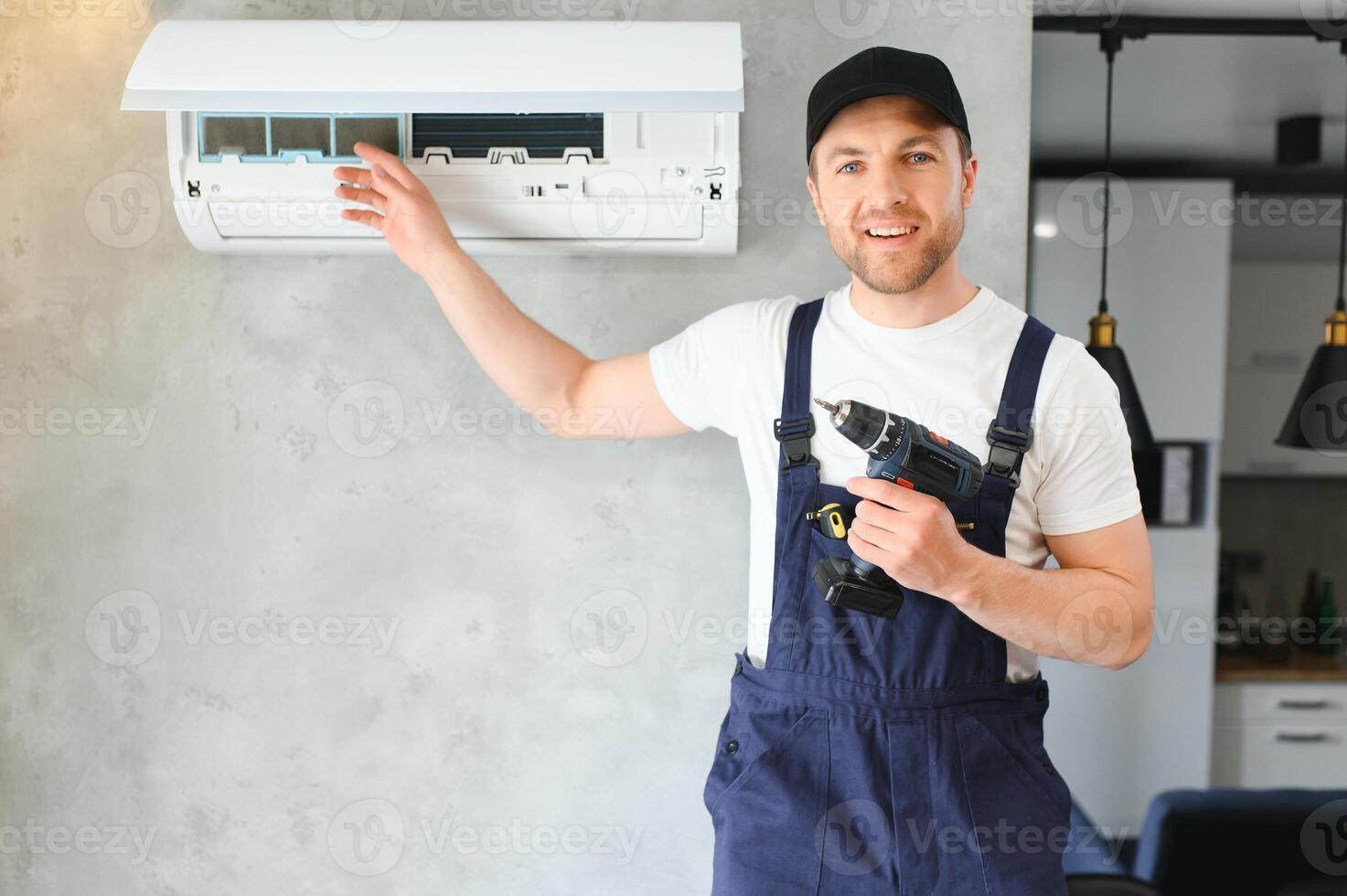 Happy Male Technician Repairing Air Conditioner. photo