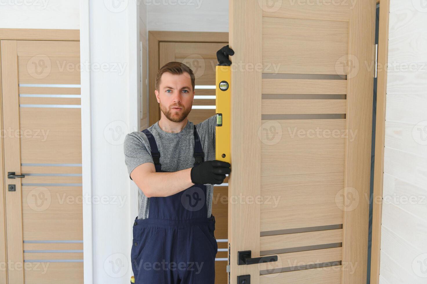 hermoso joven hombre instalando un puerta en un nuevo casa construcción sitio. foto