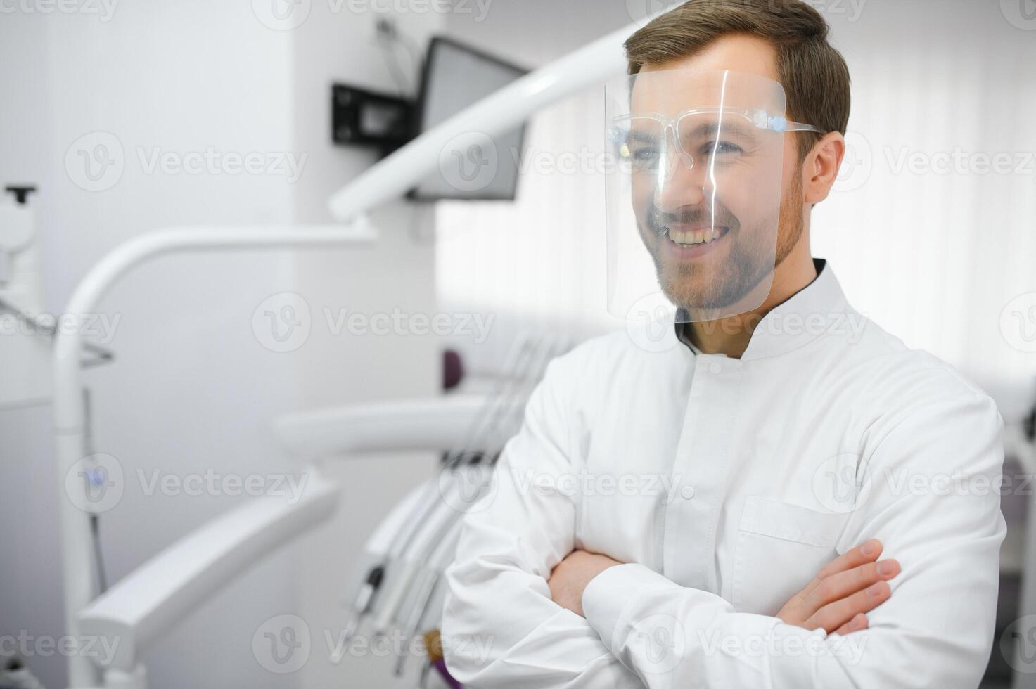 Young male dentist in clinic photo