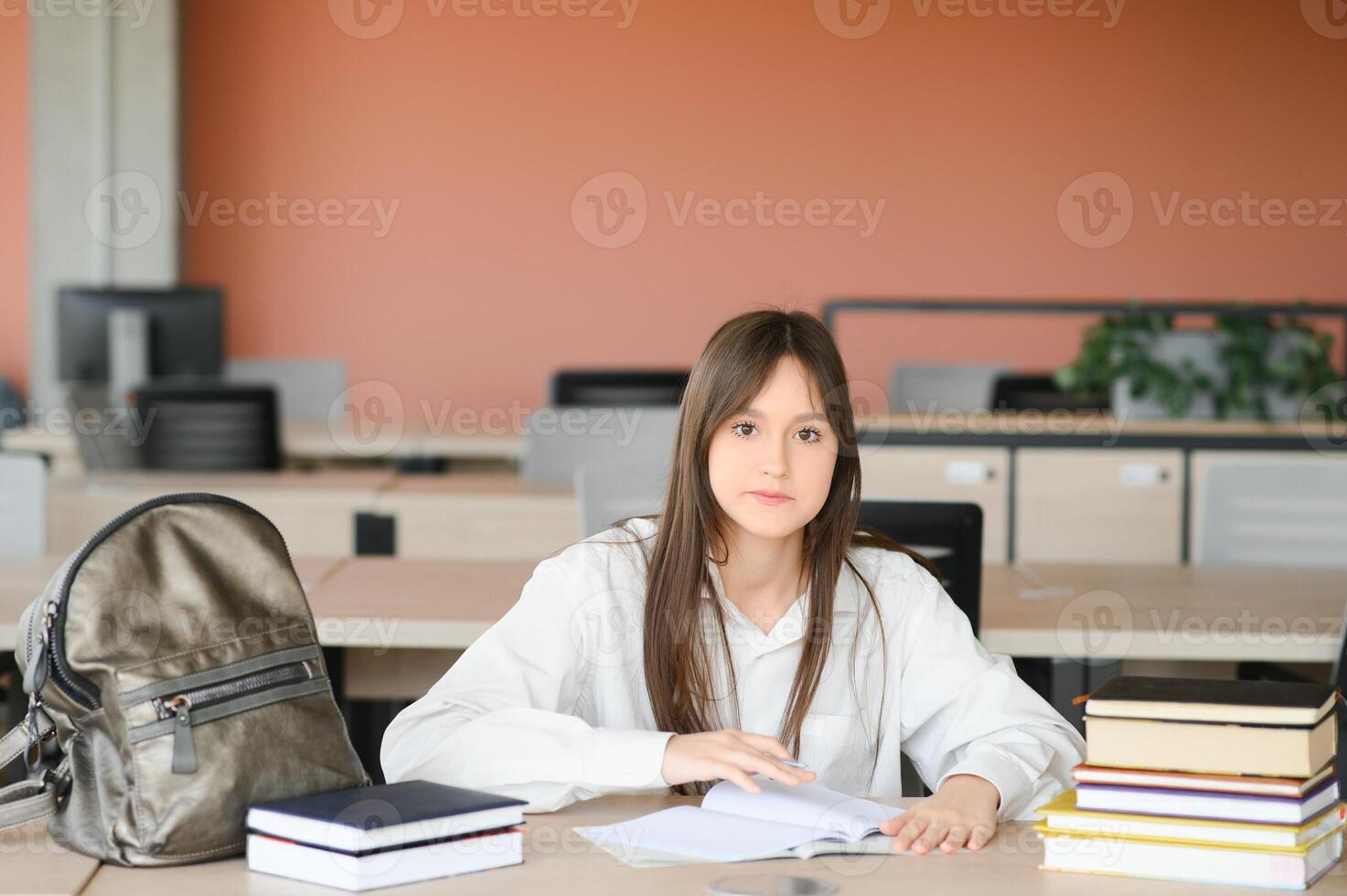 education and school concept - student girl studying and reading book at school. photo