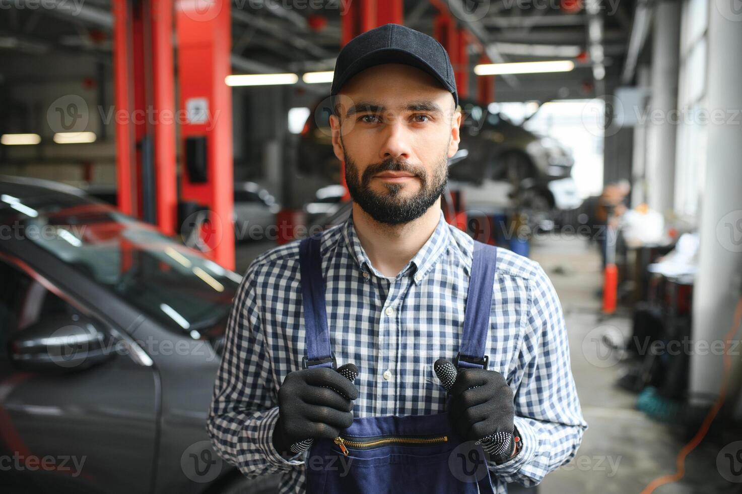 Professional car mechanic working in auto repair service. photo