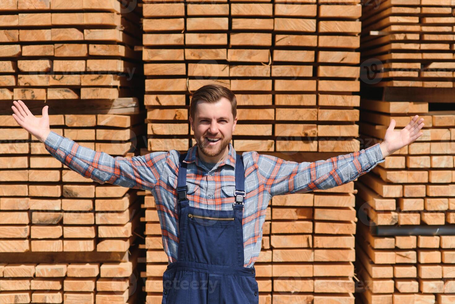 Joiner in uniform check boards on timber mill photo