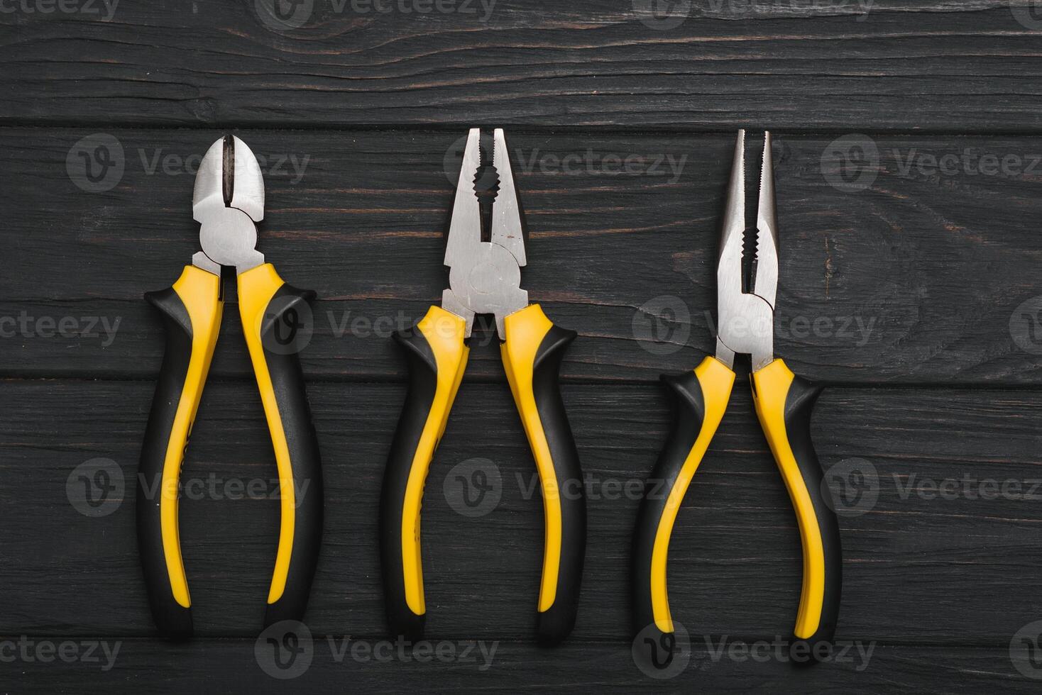 Set of assorted work carpentry and locksmith tools on a dark wooden background with copy space photo