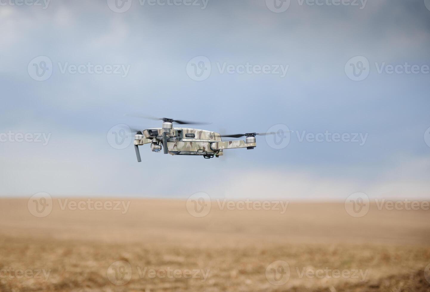 Portable quadcopter against a blue sky with white Cirrus clouds. photo