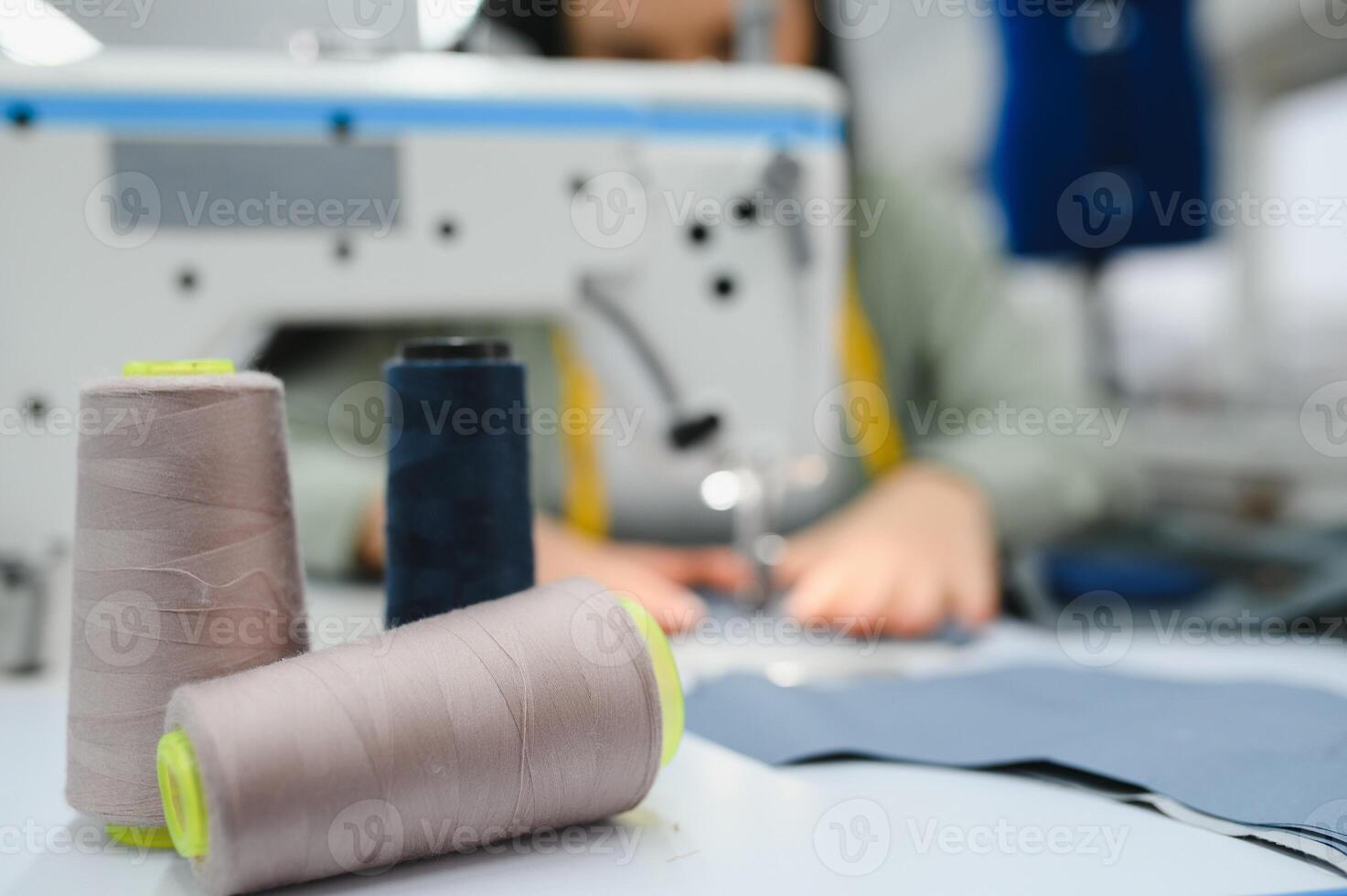 Seamstress at work. Dressmaker making clothes in modern studio. photo