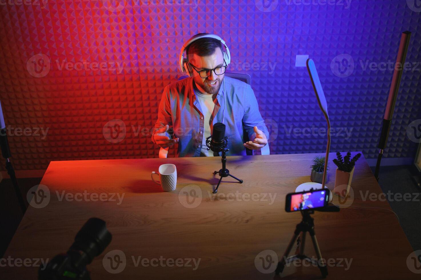 Young blogger recording video indoors. photo